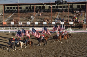 Flags flying at the start of the Cody rodeo.